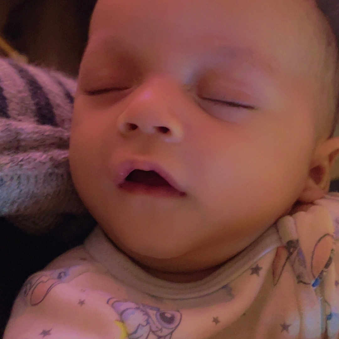 Rylannd joined the competition — help win amazing prizes! baby, blanket, cartoon_print, closeup, cute, eyes_closed, face, hand, head, indoor, infant, mouth_open, newborn, onesie, pillow, portrait, skin, sleep, sleeping, soft_lighting