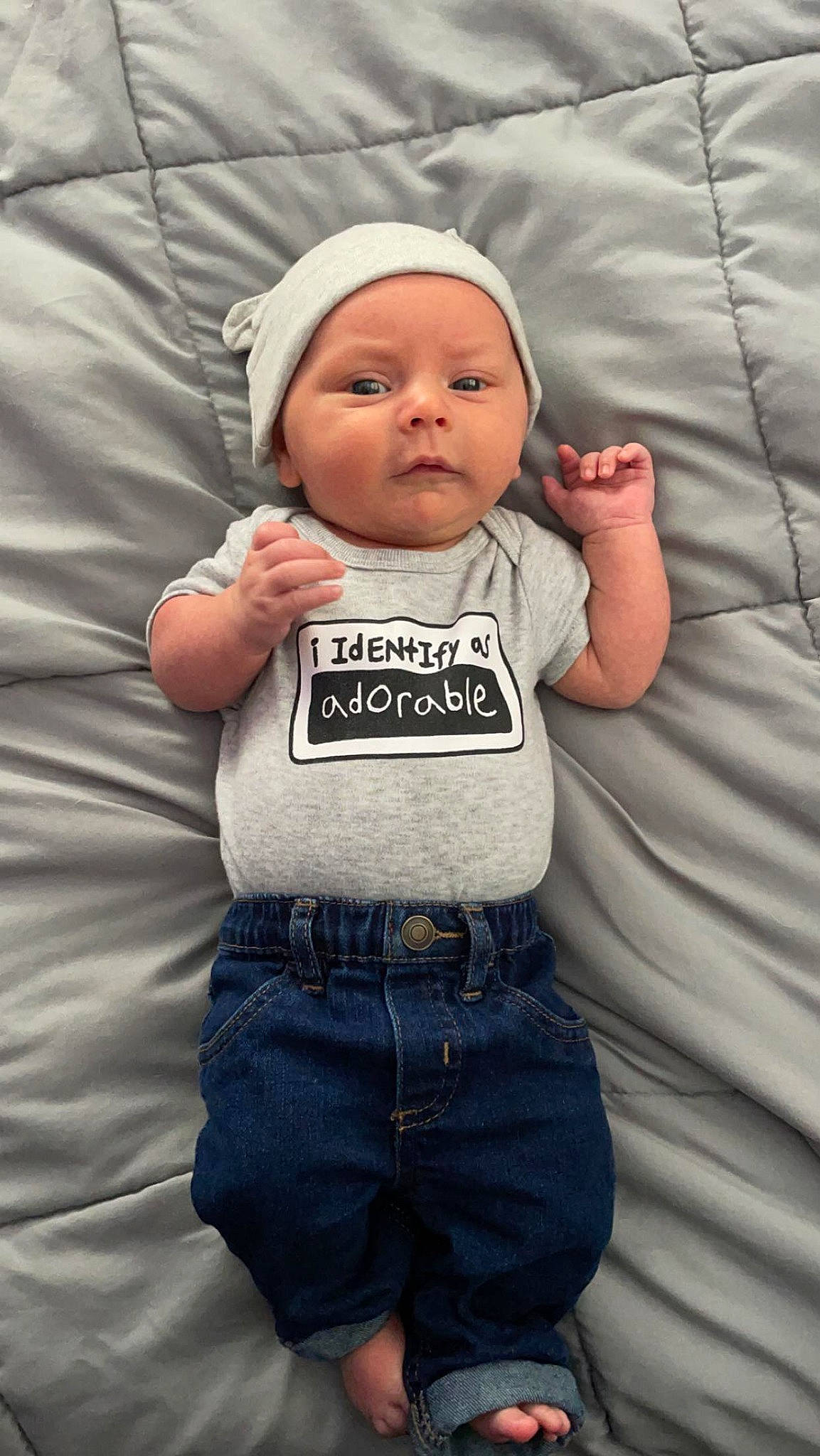 Jay joined the competition — help win amazing prizes! baby, baby_toddler_clothing, belt, cap, cheek, child, comfort, cool, finger, gesture, grey, happy, headwear, outerwear, person, product, skin, sleeve, standing, t_shirt