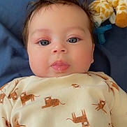 Lucille is registered to the contest to win money with this photo: adorable, baby, blue_blanket, child, clothing, cute, face, giraffe_toy, hair, indoor, infant, lying_down, onesie, person, plush_toy, portrait, smiling, soft_toy, tiger_print, young_child