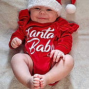 Mattie is registered to the contest to win money with this photo: baby, infant, smile, red_clothing, santa_hat, christmas, holiday, cute, lying_down, blanket, soft_texture, festive, happy, child, skin, hand, foot, indoors, portrait, cozy