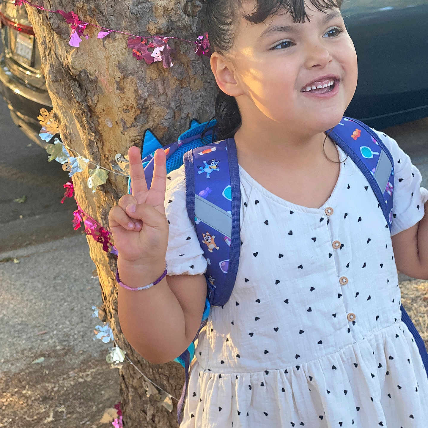 Adele joined the competition — help win amazing prizes! backpack, bangs, bracelet, candid, car, child, first_day, girl, hair_bow, happy, heart_pattern, outdoor, peace_sign, portrait, smiling, street, sunlight, tree, tree_bark, white_dress