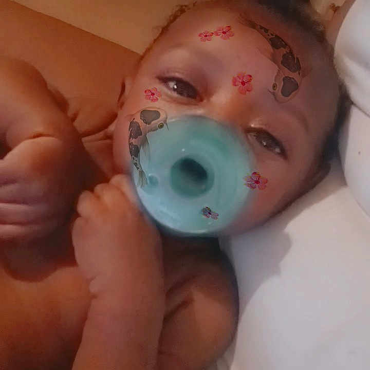 Kailip joined the competition — help win amazing prizes! animal_patches, baby, butterflies, child, closeup, cute, expression, face_filter, hand, head, human, indoors, infant, lying_down, pacifier, pillow, portrait, relaxed, skin, young