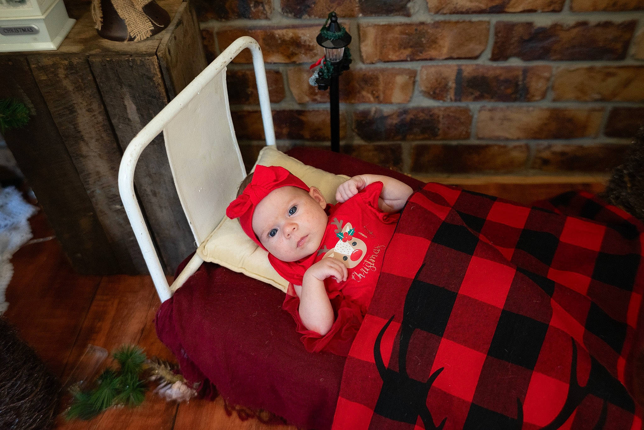 Freya is registered to the contest to win money with this photo: baby, brick, chair, child, comfort, doll, event, flooring, grass, hardwood, headwear, pattern, person, plaid, room, sitting, tartan, textile, toddler, toy