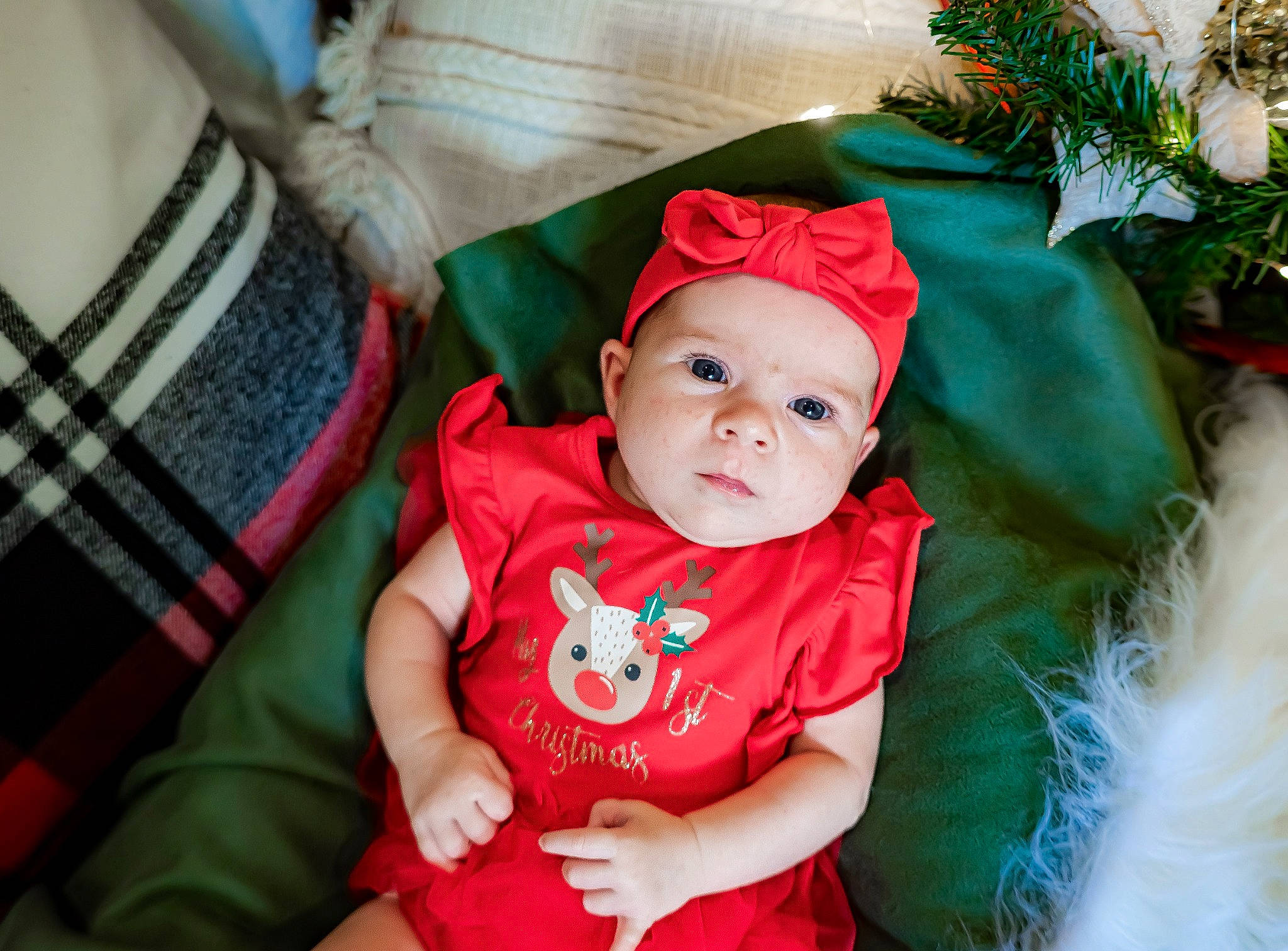 Freya is registered to the contest to win money with this photo: baby, baby_toddler_clothing, child, christmas, christmas_eve, costume_hat, event, fashion_accessory, fictional_character, fun, grass, happy, hat, headwear, holiday, pattern, person, plaid, sitting, smile