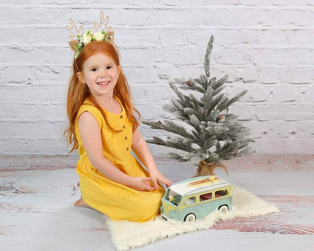 Theia joined the competition — help win amazing prizes! automotive_design, automotive_exterior, child, grass, happy, headpiece, jewellery, joy, motor_vehicle, person, plant, sitting, smile, tire, toddler, toy, toy_vehicle, tree, vehicle, vehicle_door