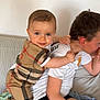 Lino participe au concours pour gagner de l'argent avec cette photo : baby, child, older_child, couch, smile, clothing, indoor, person, face, hug, affection, cute, sitting, happy, family, casual, shorts, tshirt, home, interaction