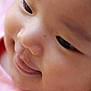 Fandana is registered to the contest to win money with this photo: baby, close_up, face, smile, pink_clothing, floral_embroidery, child, skin, innocence, joy, portrait, cute, happy, young_child, soft_skin, eyelashes, nose, mouth, cheeks, infant