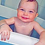 baby, infant, bathtub, bath_time, smile, teeth, wet_skin, chubby_cheeks, hand, bracelet, tile_wall, bath_rim, blue_bathtub, sitting, portrait, cute, joyful, close_up, toddler, bathroom