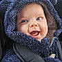 baby, child, smile, face, hood, jacket, seatbelt, car_seat, blue, fur, cute, happy, infant, car_interior, person, young_child, closeup, warm_clothing, expression, outdoor_light