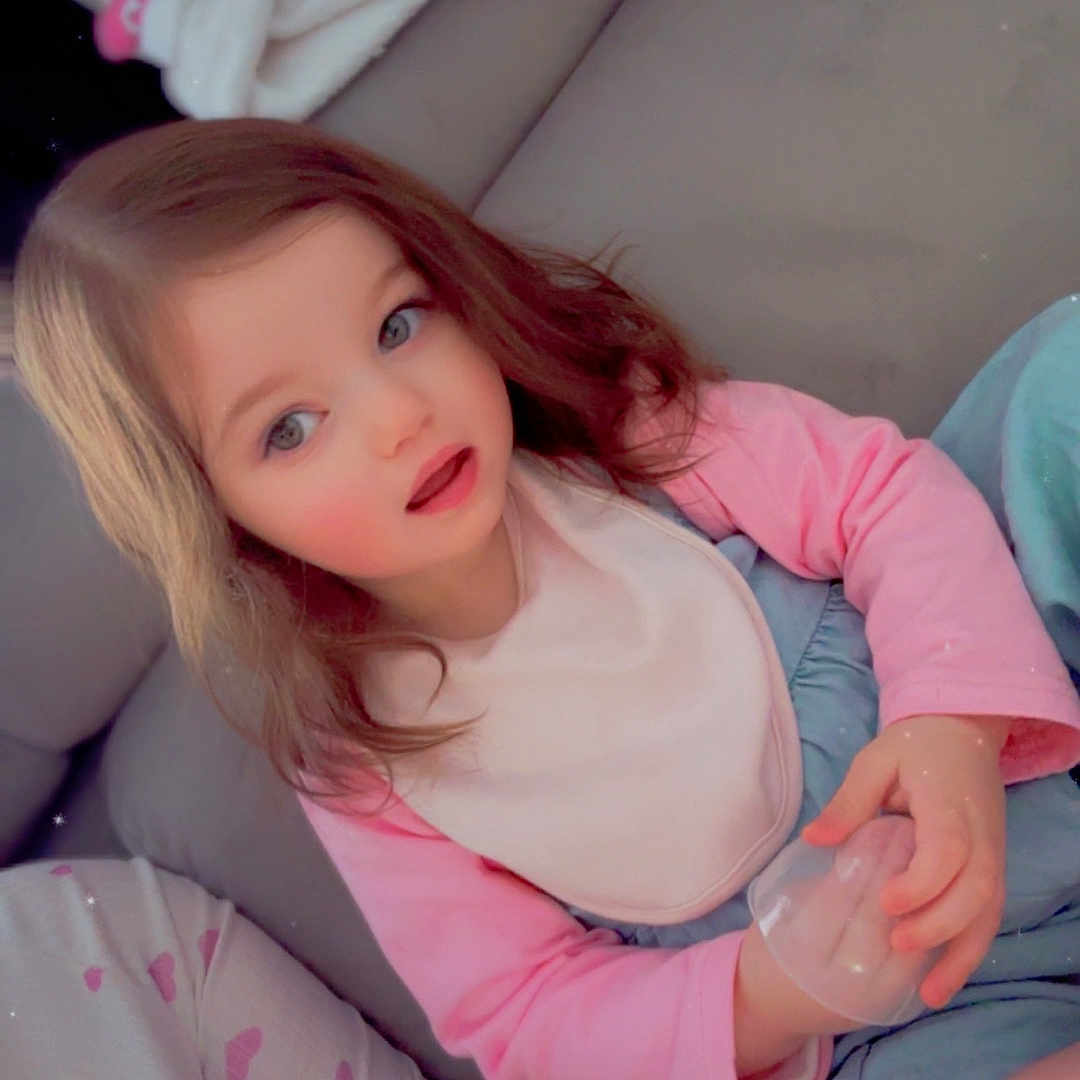 Elsie joined the competition — help win amazing prizes! bodypart, child, clothing, couch, dress, face, female, finger, flower, furniture, girl, hand, happy, head, person, photography, plant, portrait, rose, sitting