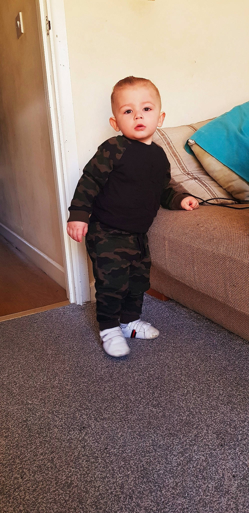 Frank is registered to the contest to win money with this photo: baby_toddler_clothing, child, comfort, couch, eye, face, flash_photography, floor, flooring, fun, hardwood, human_leg, knee, leg, person, sleeve, sock, thigh, toddler, waist