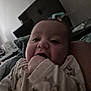 Lance is registered to the contest to win money with this photo: baby, infant, hand, chewing, closeup, face, person, indoors, sleepwear, cozy, child, young, cute, expression, skin, furniture, blanket, room, portrait, casual