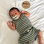 Giovanni joined the competition — help win amazing prizes! baby, baby_clothes, blanket, child, close_up, cute, indoors, infant, lying_down, milestone, newborn, one_month, pacifier, peaceful, portrait, skin, sleepy, soft_texture, striped_clothing, wooden_sign