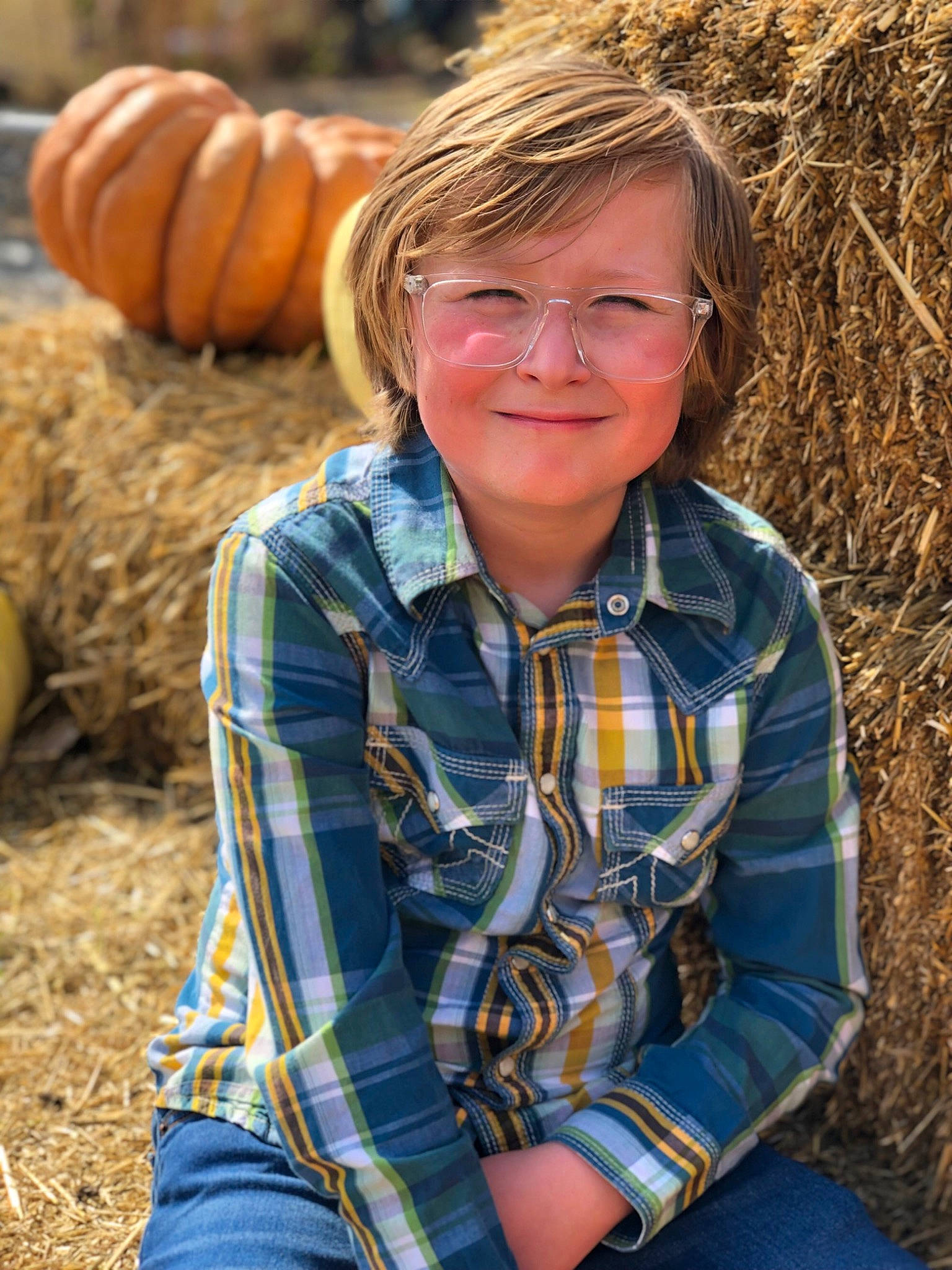 North is registered to the contest to win money with this photo: calabaza, cucurbita, eye, glasses, gourd, grass, hair, happy, head, jeans, joy, leaf, natural_foods, people_in_nature, person, photograph, plaid, plant, pumpkin, smile