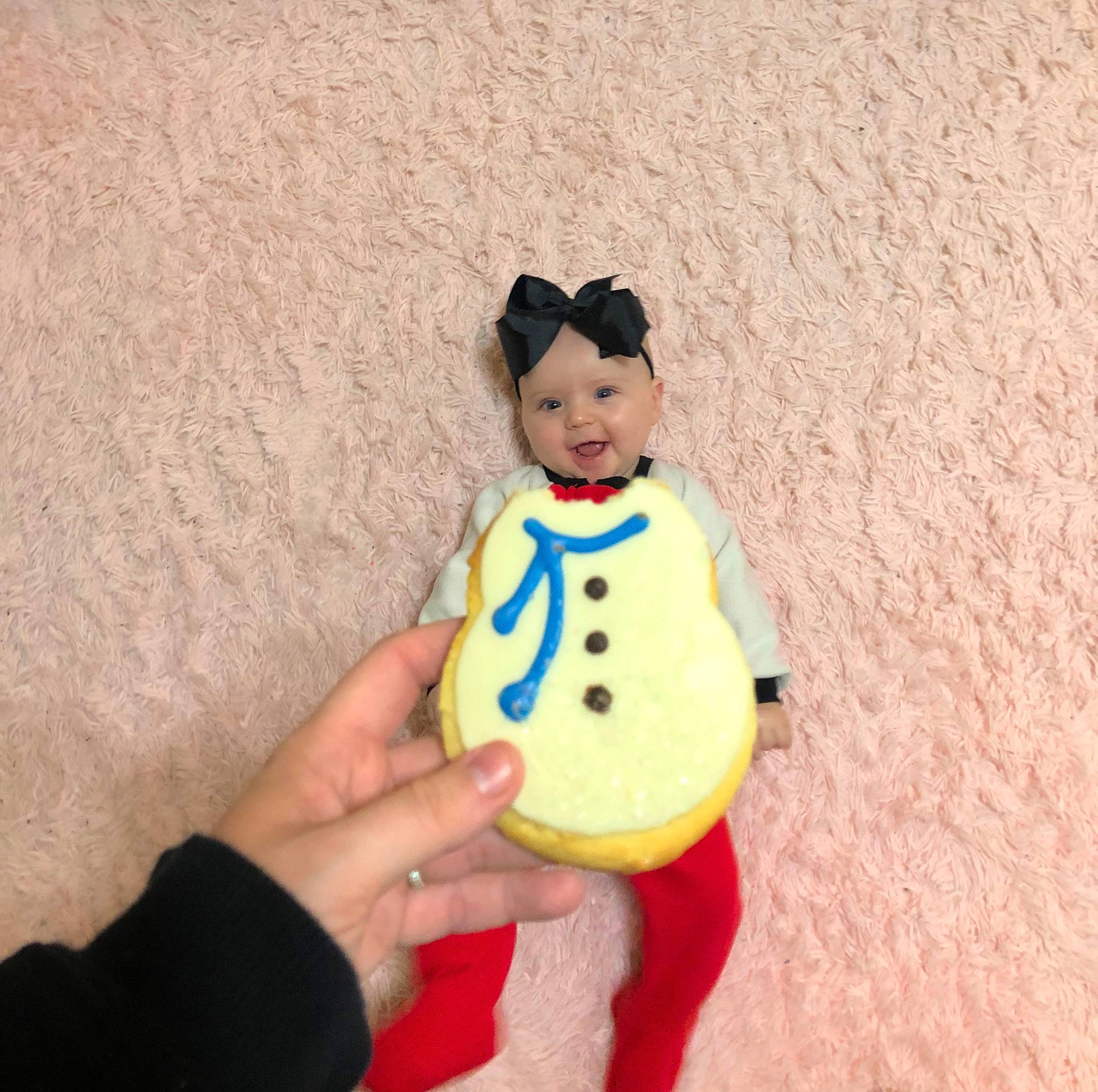Magnolia is registered to the contest to win money with this photo: baby_toddler_clothing, christmas_ornament, costume_hat, doll, fashion_accessory, finger, fun, gesture, hair, happy, hat, head, headwear, ornament, person, sleeve, smile, stuffed_toy, thumb, toy