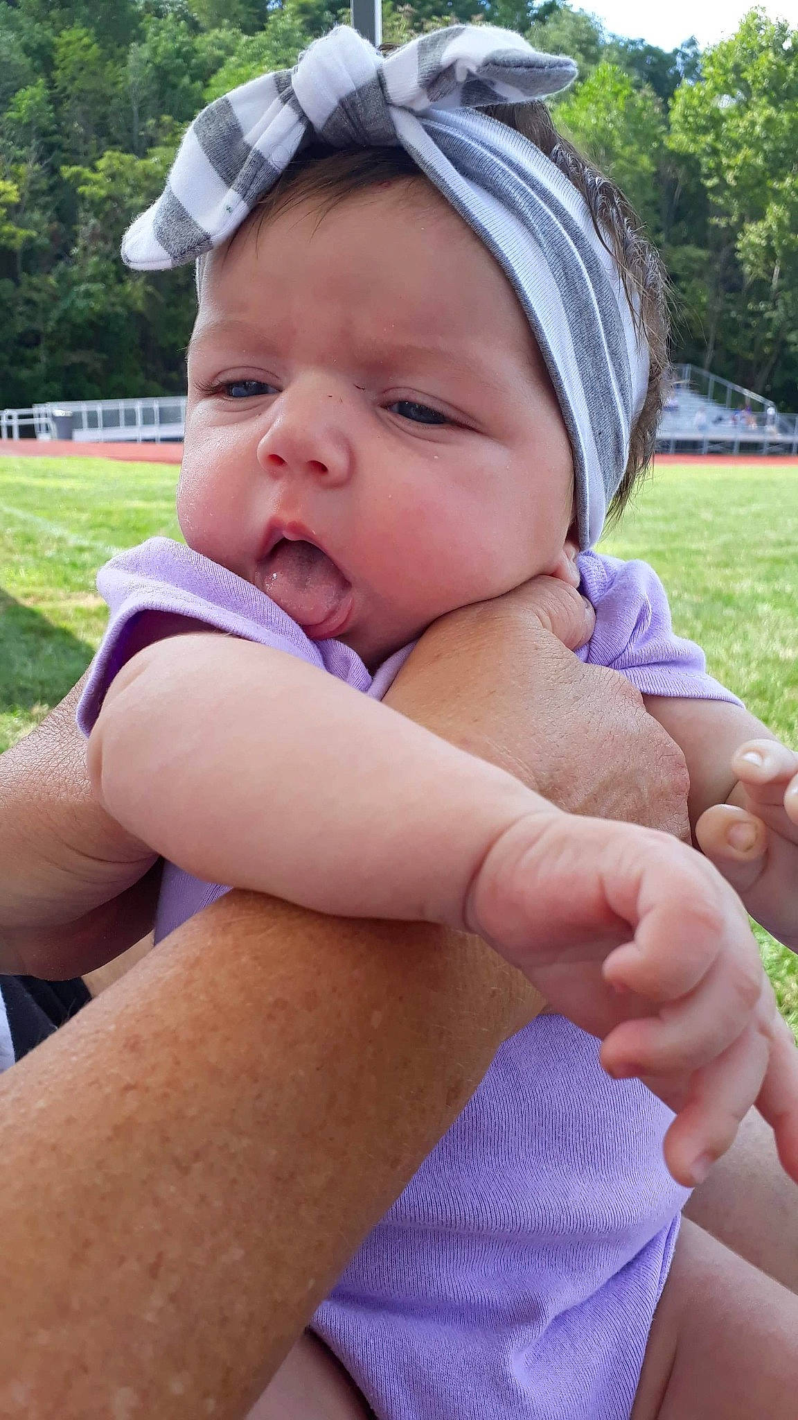 Jazlynn joined the competition — help win amazing prizes! baby, child, finger, gesture, grass, hand, person, skin, smile, thumb, toddler