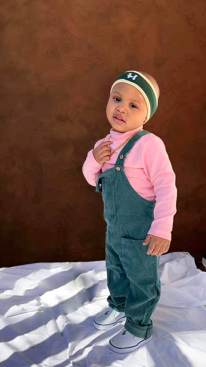 Jordon is registered to the contest to win money with this photo: baby, baby_toddler_clothing, cap, child, electric_blue, fashion_accessory, flash_photography, fun, gesture, happy, headwear, human_body, jacket, magenta, outerwear, person, personal_protective_equipment, sitting, sleeve, smile