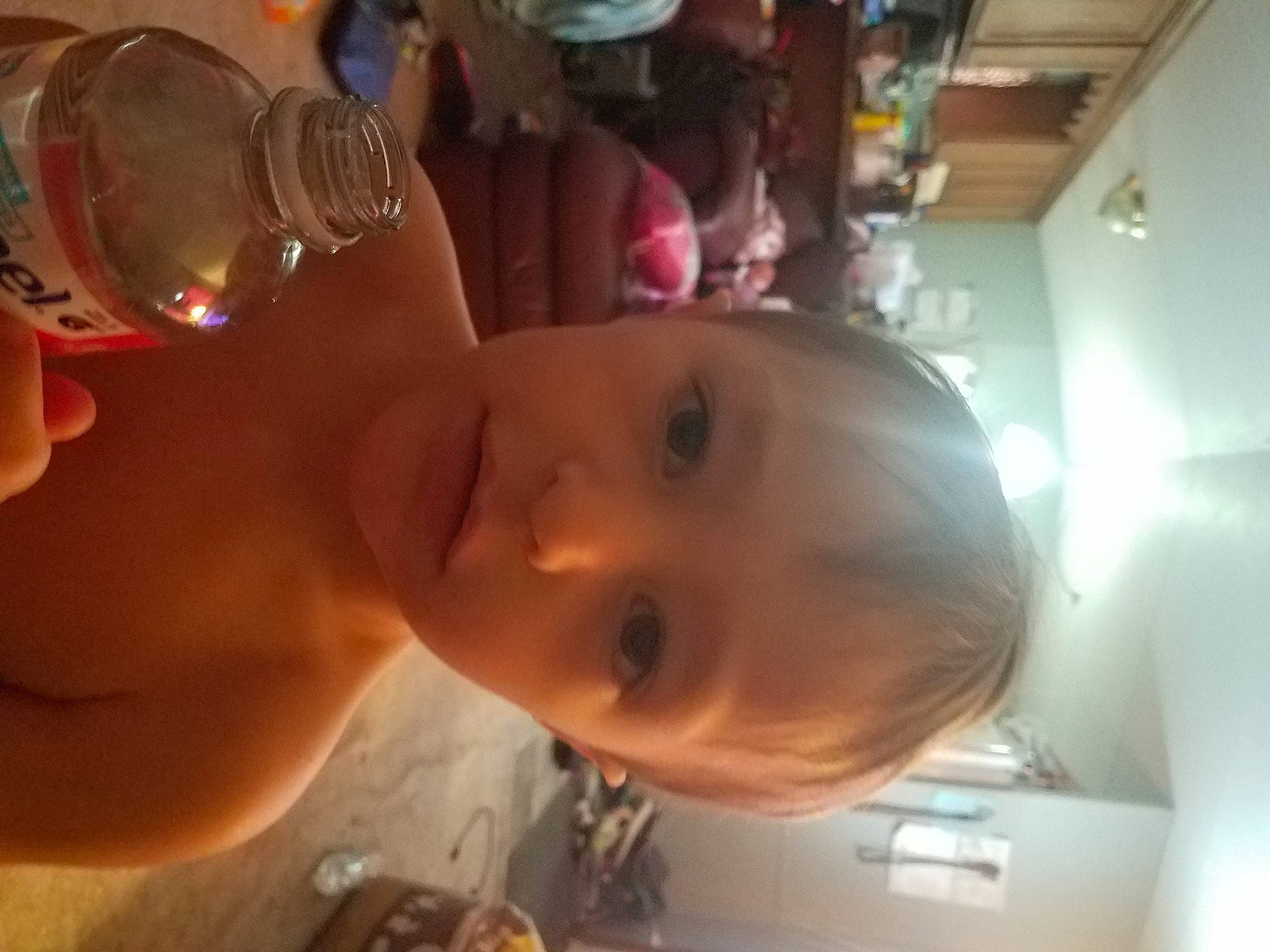 Asher is registered to the contest to win money with this photo: baby, cheek, child, drink, drinking, drinkware, ear, eyelash, fun, happy, liquid_bubble, mouth, nose, person, plastic_bottle, skin, smile, tableware, toddler, vacation