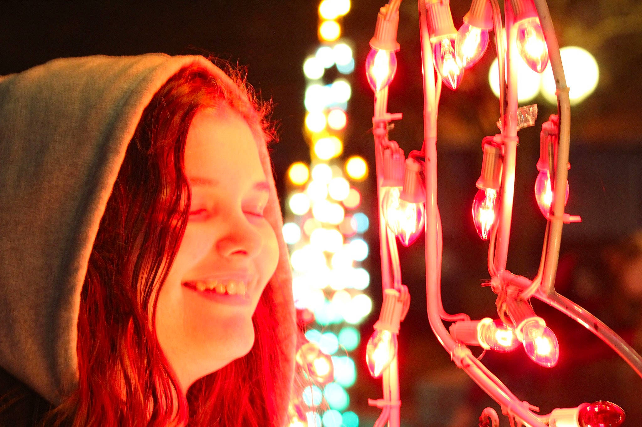 Sylvia is registered to the contest to win money with this photo: christmas, christmas_decoration, christmas_lights, electricity, entertainment, event, fun, happy, holiday, interior_design, lantern, leisure, light, lighting, magenta, neon, night, person, red, smile