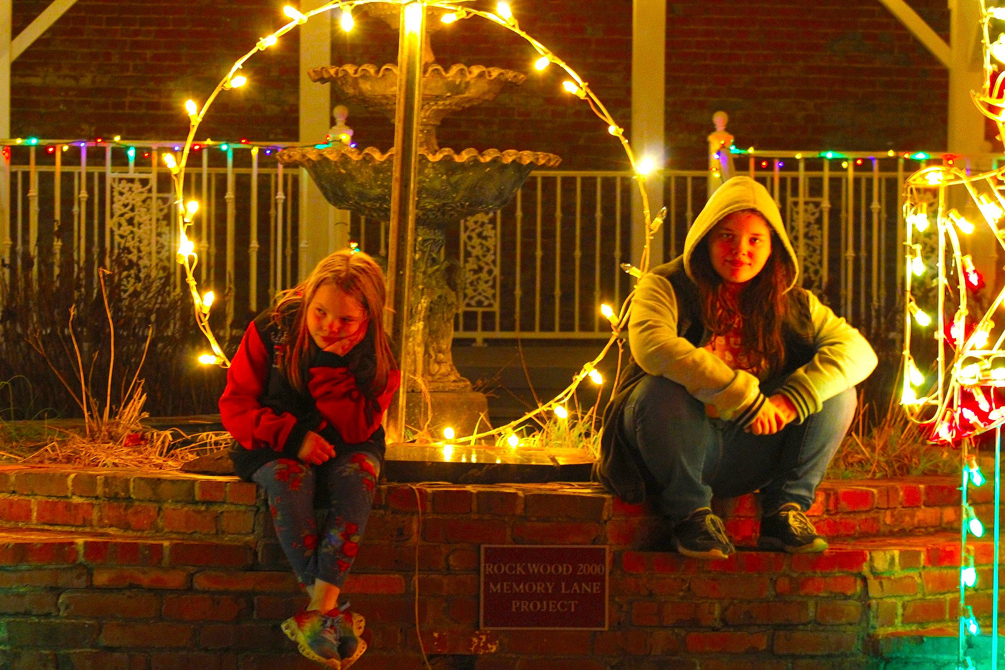 Sylvia is registered to the contest to win money with this photo: christmas, christmas_decoration, christmas_lights, circle, darkness, electricity, entertainment, event, flash_photography, fun, grass, happy, headwear, holiday, joy, leisure, midnight, neon, night, person