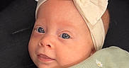Scottie joined the competition — help win amazing prizes! baby, infant, headband, bow, green_clothing, daisies, cute, portrait, face, eyes, smile, child, soft_light, closeup, indoors, cozy, apparel, fabric, person, adorable