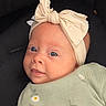 baby, infant, headband, bow, green_clothing, daisies, cute, portrait, face, eyes, smile, child, soft_light, closeup, indoors, cozy, apparel, fabric, person, adorable
