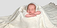 Dolly joined the competition — help win amazing prizes! baby, infant, sleeping, blanket, knitted, white, soft, cute, peaceful, wrapped, arms, face, portrait, newborn, cozy, child, resting, indoors, adorable, calm