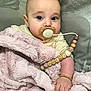 baby, pacifier, blanket, beads, bracelet, infant, cute, child, soft_texture, face, hand, closeup, indoor, sleepwear, person, comfort, rest, portrait, pink, accessory