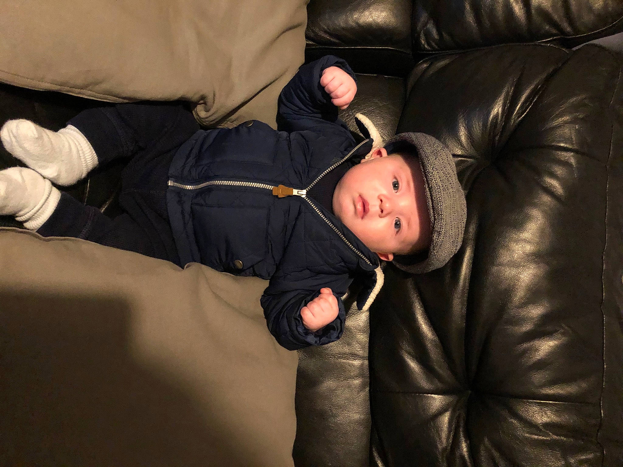 Albert is registered to the contest to win money with this photo: baby, cheek, child, comfort, couch, darkness, flash_photography, fun, headwear, jacket, leather, leather_jacket, linens, nap, outerwear, person, room, sitting, sleep, sleeve