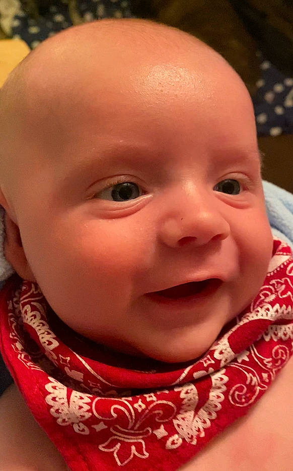 Harlan is registered to the contest to win money with this photo: baby, baby_toddler_clothing, cheek, chin, close_up, eye, eyebrow, eyelash, grass, happy, iris, lip, mouth, nose, person, pink, red, skin, sleeve, smile