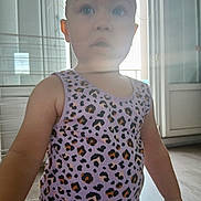 Elysianna participe au concours pour gagner de l'argent avec cette photo : arm, backlight, child, clothing, curious, daylight, door, expression, face, floor, hair, home, indoor, leopard_print, skin, soft_light, standing, tank_top, toddler, window
