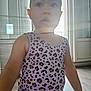 arm, backlight, child, clothing, curious, daylight, door, expression, face, floor, hair, home, indoor, leopard_print, skin, soft_light, standing, tank_top, toddler, window