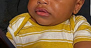 Quilan is registered to the contest to win money with this photo: baby, casual, child, closeup, curious, device, expression, face, hair, hand, indoor, looking_down, person, portrait, sitting, skin, striped_clothing, toddler, yellow_shirt, young_child