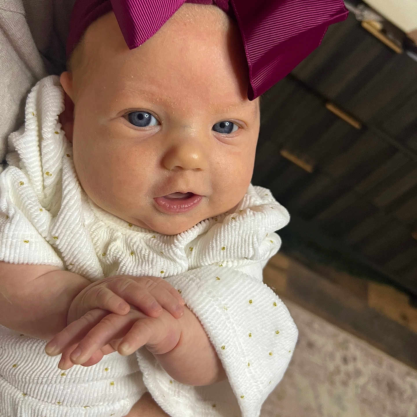 Tatum joined the competition — help win amazing prizes! baby, bodypart, bonnet, cap, clothing, dress, face, finger, hand, happy, hat, head, knitwear, newborn, pants, person, photography, portrait, smile, sweater