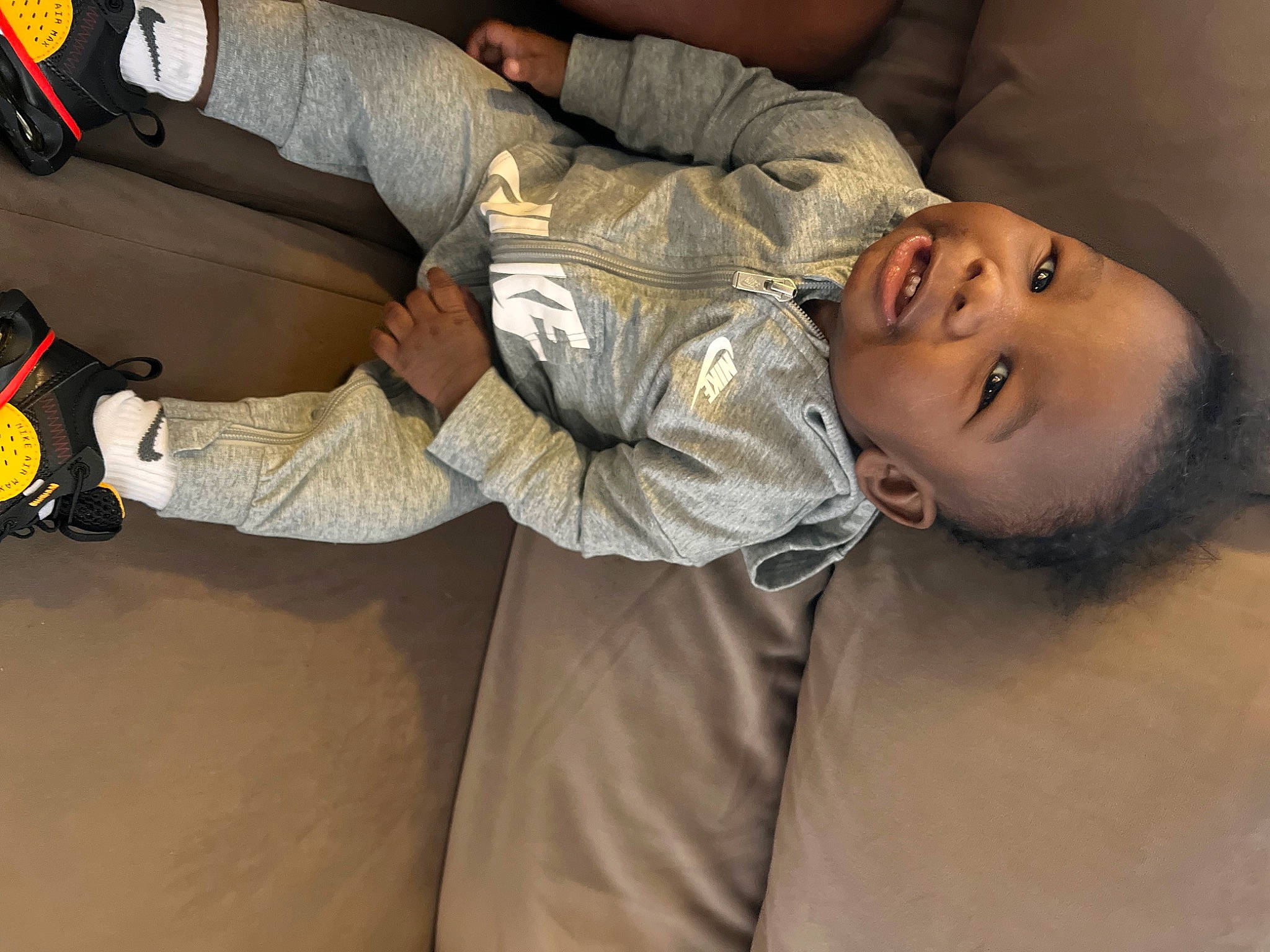 Dion is registered to the contest to win money with this photo: auto_part, baby, child, comfort, elbow, flash_photography, fun, gesture, glove, happy, nose, person, room, smile, toddler, uniform