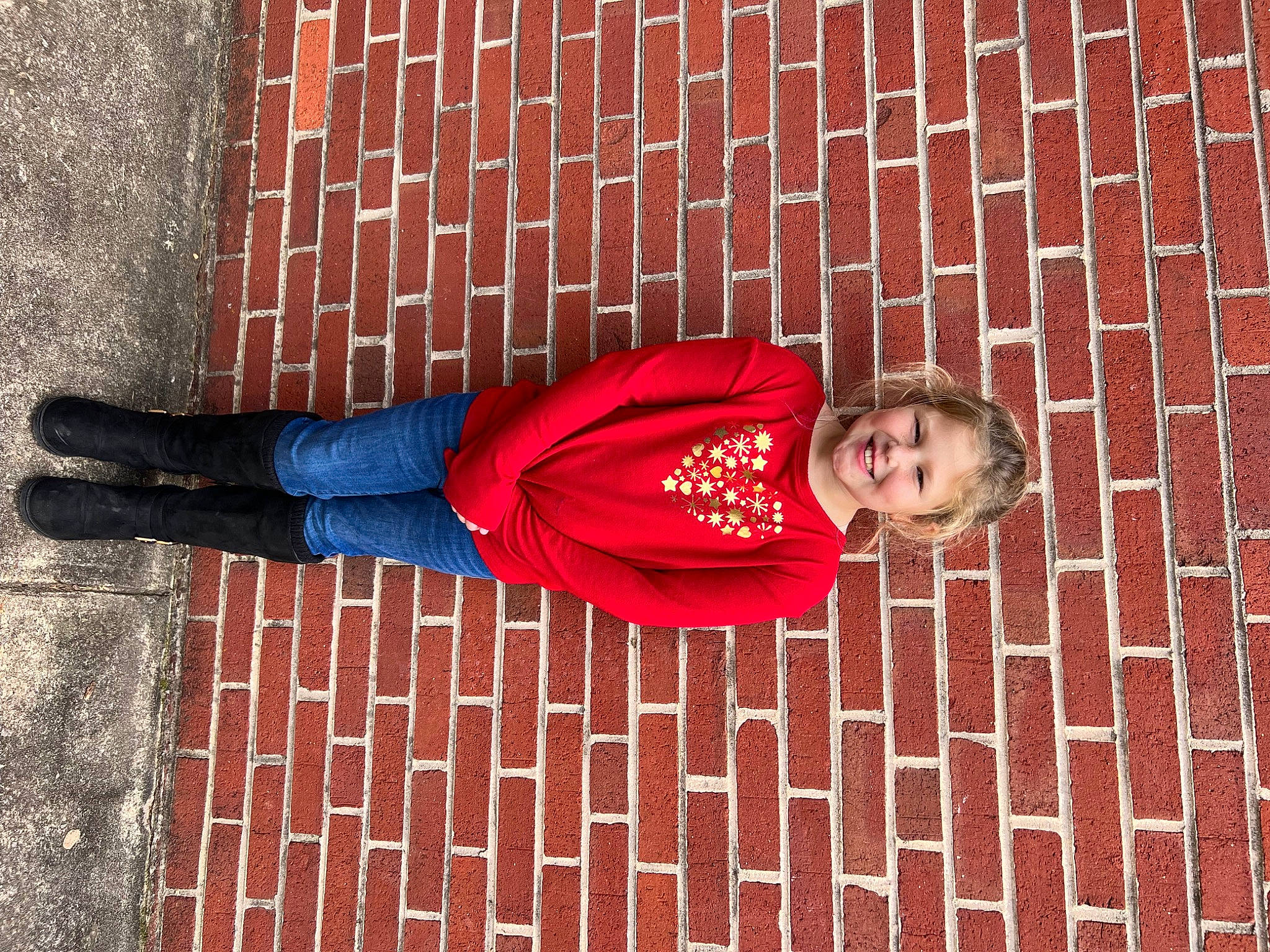 Kaylee is registered to the contest to win money with this photo: brick, brickwork, carmine, cobblestone, denim, electric_blue, flooring, human_leg, jeans, joy, leg, line, pattern, person, red, road_surface, smile, sportswear, textile, thigh