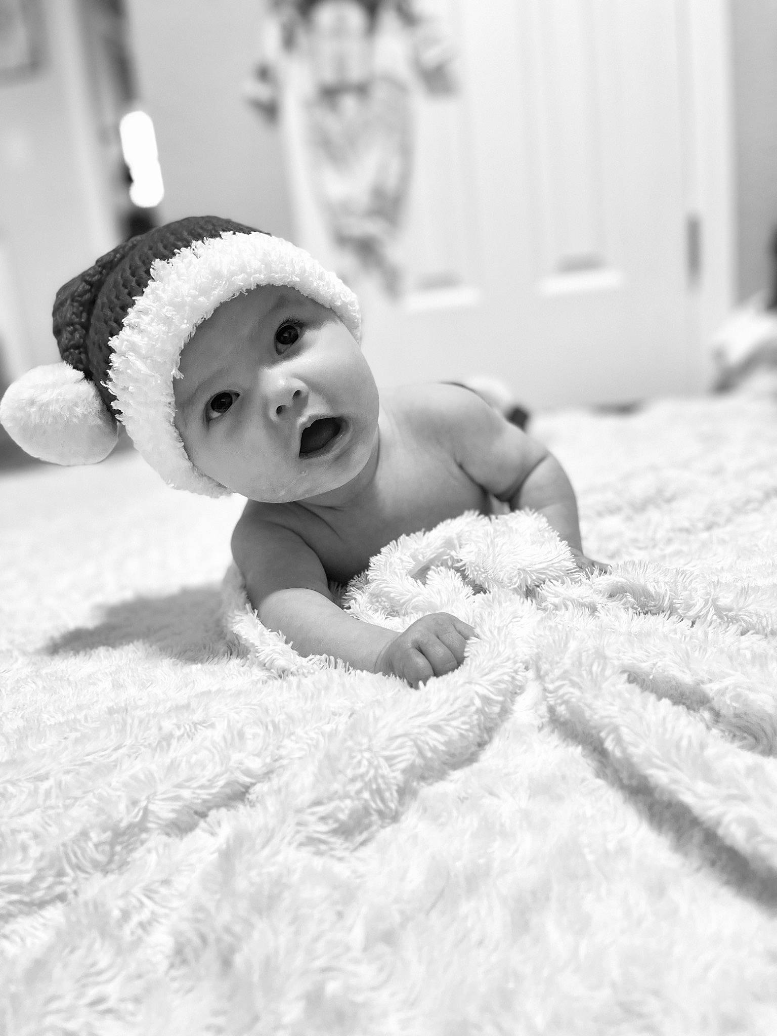 Ellie joined the competition — help win amazing prizes! baby, black_and_white, close_up, comfort, eyebrow, eyelash, finger, flash_photography, floor, flooring, happy, headgear, headpiece, headwear, linens, monochrome, monochrome_photography, person, smile, style