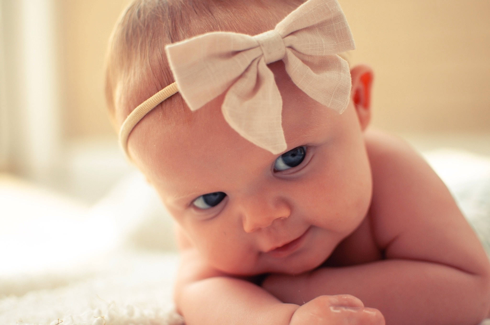 Delanie is registered to the contest to win money with this photo: baby, cheek, child, close_up, ear, eye, face, fashion_accessory, forehead, hair_accessory, hand, head, headband, headgear, lip, person, photography, pink, skin, smile