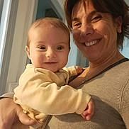 Ethan participe au concours pour gagner de l'argent avec cette photo : baby, woman, smiling, happy, indoor, person, child, holding, face, portrait, family, love, affection, clothing, sweater, skin, hand, head, hair, light