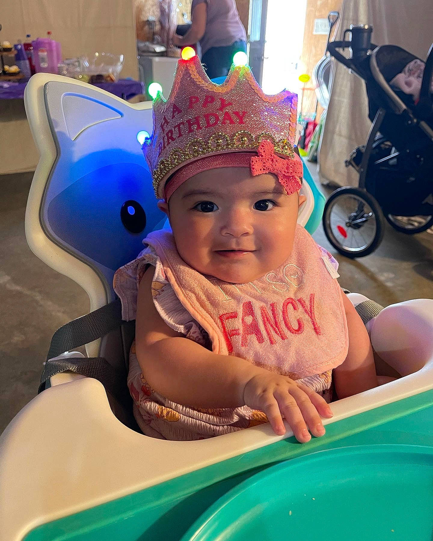 Kennedy is registered to the contest to win money with this photo: baby, baby_products, blue, cap, child, costume_hat, event, eye, fashion_accessory, fun, happy, hat, headwear, joy, leisure, party_hat, party_supply, person, personal_protective_equipment, pink