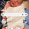 baby, sleeping, towel, person, arm, phone_screen, app_icons, advertisement, word_jumble, indoor, closeup, human, child, blanket, comfortable, resting, mobile, technology, screen, casual