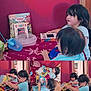 child, children, books, reading, table, toys, indoor, red_wall, container, doorway, curiosity, playful, learning, striped_shirt, short_hair, long_hair, furniture, blanket, person, young