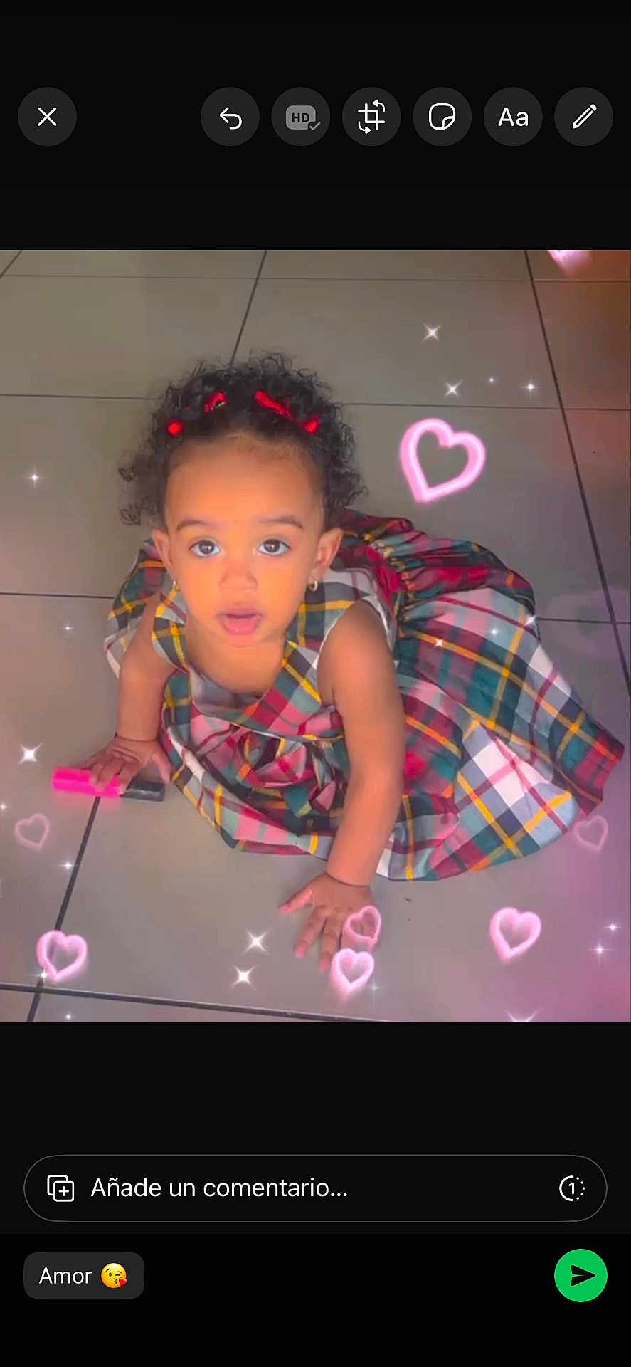 Gabiellies joined the competition — help win amazing prizes! child, toddler, plaid_dress, curly_hair, hair_bows, earrings, looking_up, sitting, tile_floor, pink_marker, hearts_filter, sparkles, floor_tiles, indoor, portrait, cute, toy, social_media_ui, comment_box, photo_filter