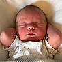 newborn, baby, sleeping, infant, arms_up, onesie, polka_dots, blanket, knitted, soft_lighting, face, peaceful, cozy, resting, closeup, portrait, skin, head, closed_eyes, cute