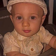 Conrad joined the competition — help win amazing prizes! baby, child, face, hat, bow_tie, high_chair, clothing, person, cute, portrait, infant, skin, eyes, sitting, indoor, expression, young, fashion, headwear, babygear