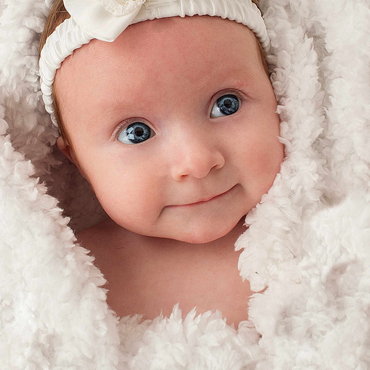 Delilah joined the competition — help win amazing prizes! accessories, baby, blanket, bonnet, cap, clothing, face, happy, hat, head, headband, hood, hoodie, knitwear, newborn, person, photography, portrait, smile, sweater