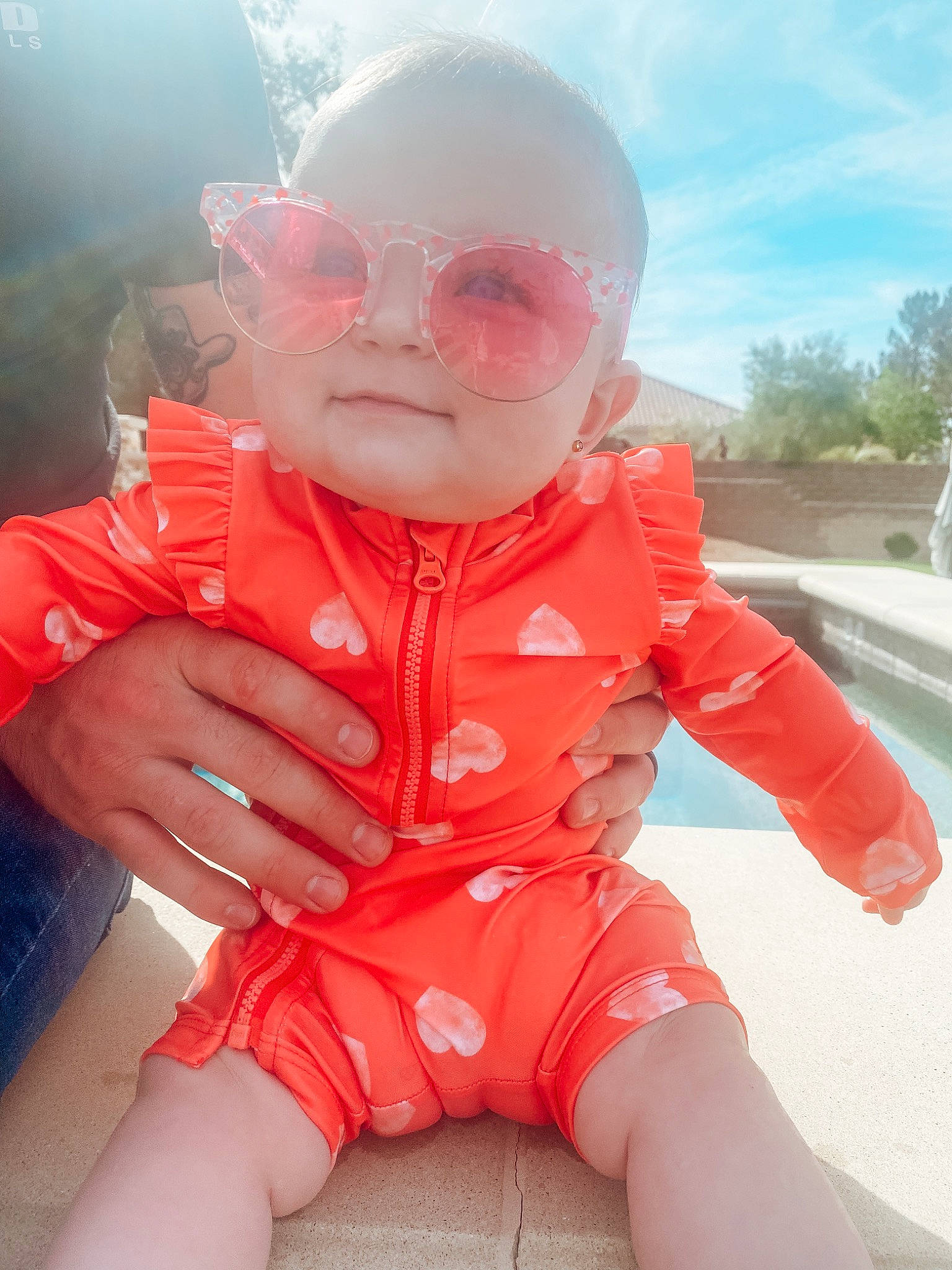 Demi joined the competition — help win amazing prizes! baby_toddler_clothing, cloud, eyewear, finger, gesture, hand, happy, helmet, lip, mouth, nose, outerwear, person, personal_protective_equipment, pink, skin, sky, sleeve, sunglasses, thumb