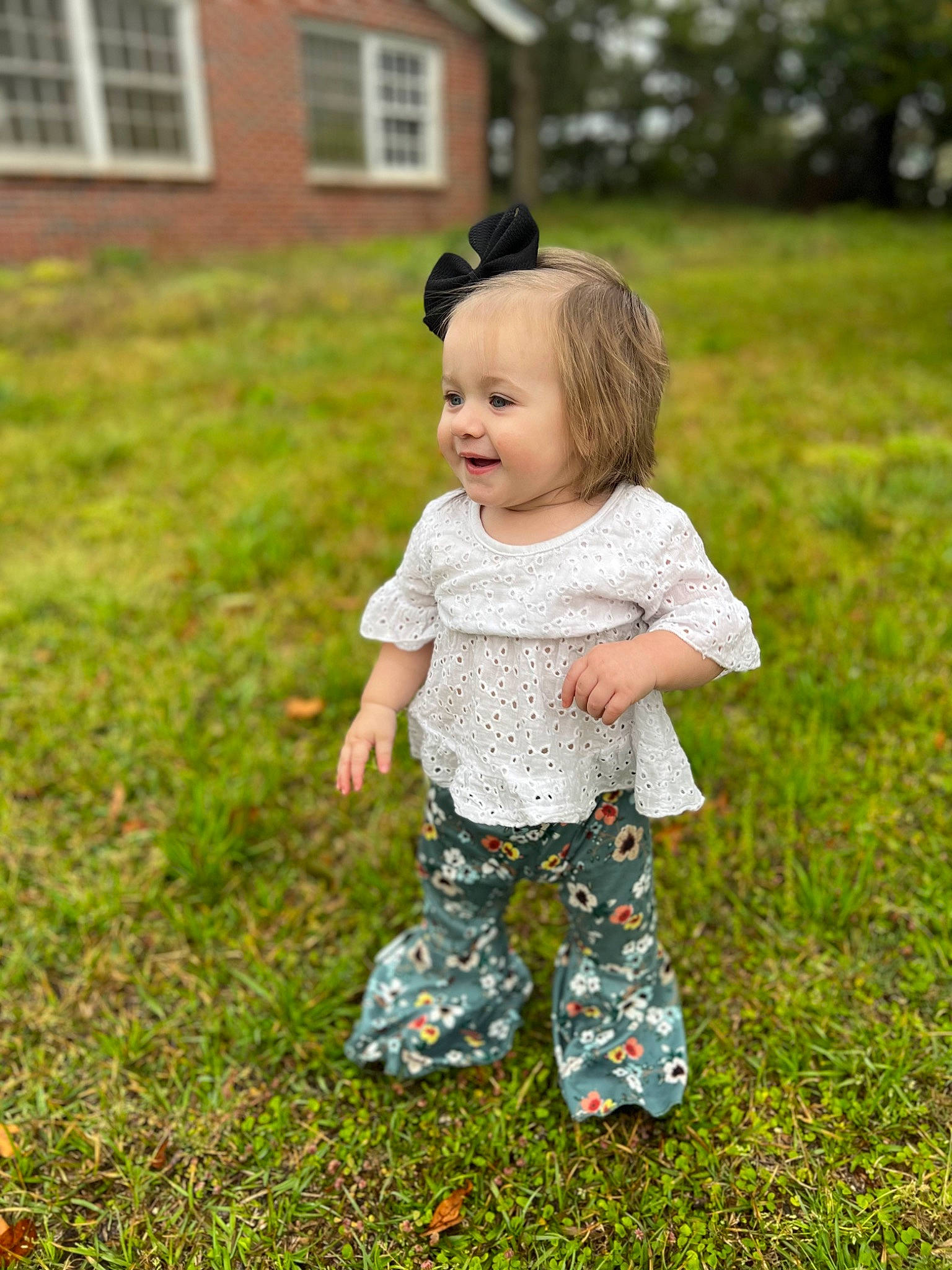 Everleigh is registered to the contest to win money with this photo: baby, baby_toddler_clothing, blond, child, fun, grass, grass_family, grassland, happy, house, landscape, lawn, leaf, meadow, people_in_nature, person, plant, smile, toddler, tree