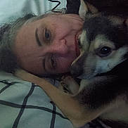 Babyboy is registered to the contest to win money with this photo: person, dog, face, closeup, snuggling, blanket, indoor, pet, fur, animal, bed, resting, cozy, cute, companion, friendship, expression, human, animal_face, warmth