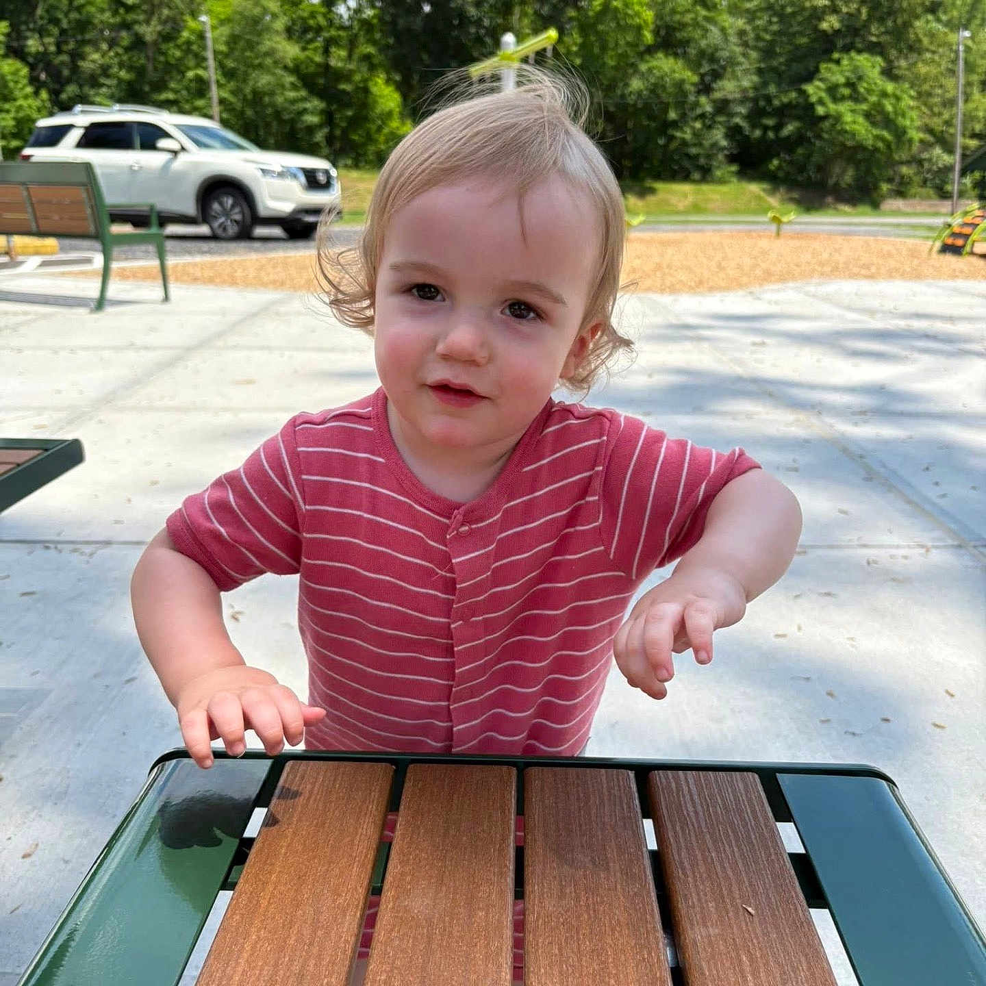 Coleson joined the competition — help win amazing prizes! bench, car, casual, child, concrete, curly_hair, daylight, face, nature, outdoor, park, person, playground, playing, red_shirt, smiling, summer, toddler, trees, young_child